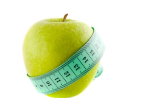 Apple with a measuring tape.